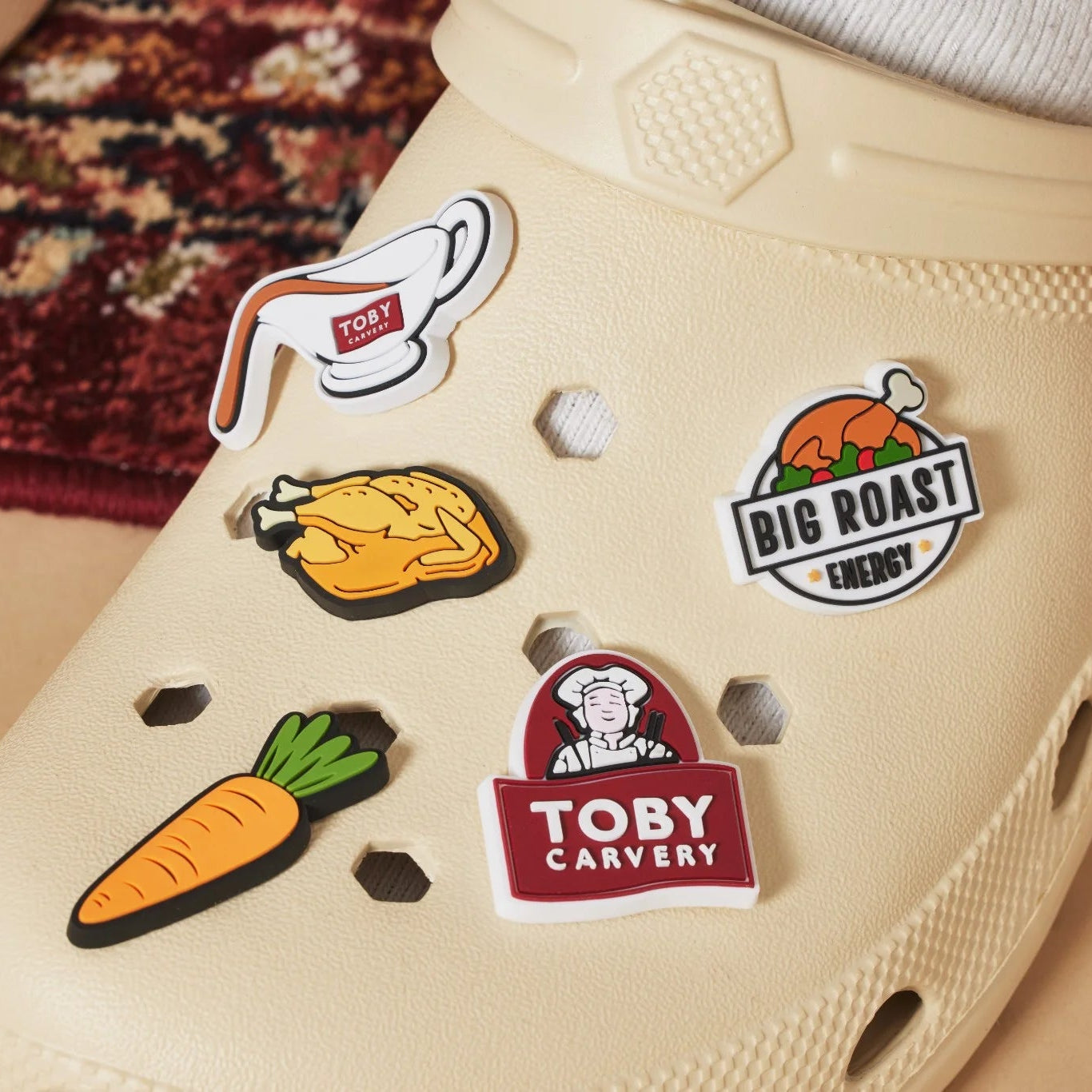 Colourful rubber pins on a beige shoe with 'Toby Carvery' branding.
