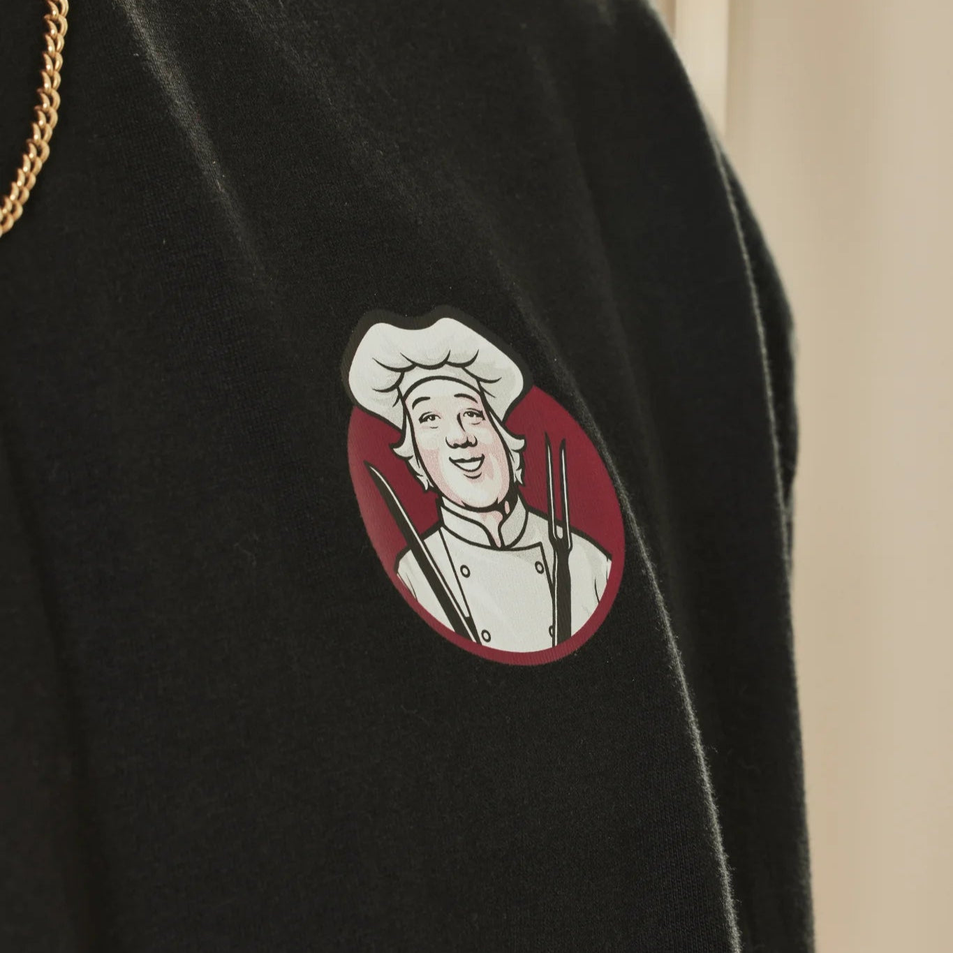 Black t-shirt with a Toby Carvery logo on a beige background
