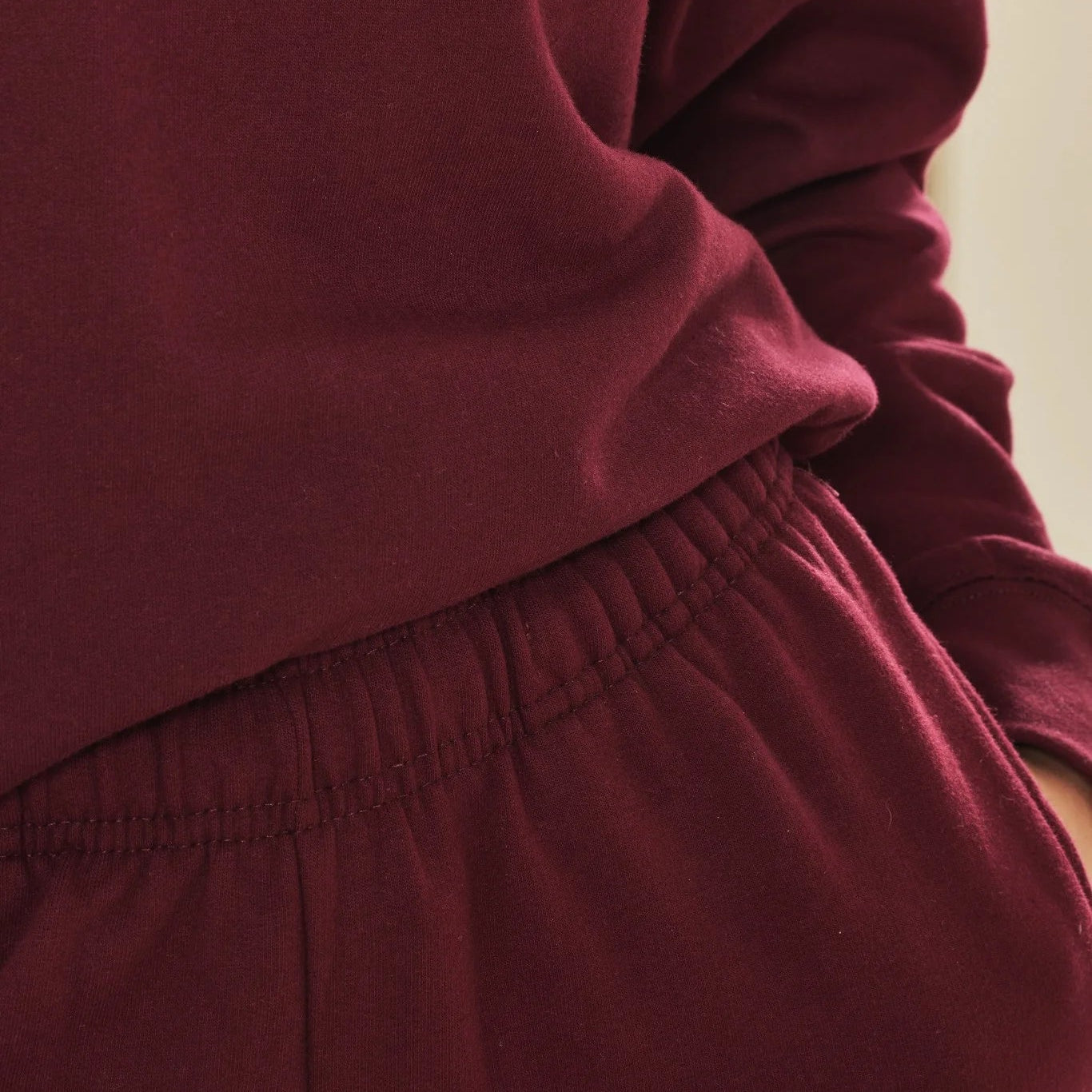 Close-up of a burgundy outfit with a focus on texture and colour.