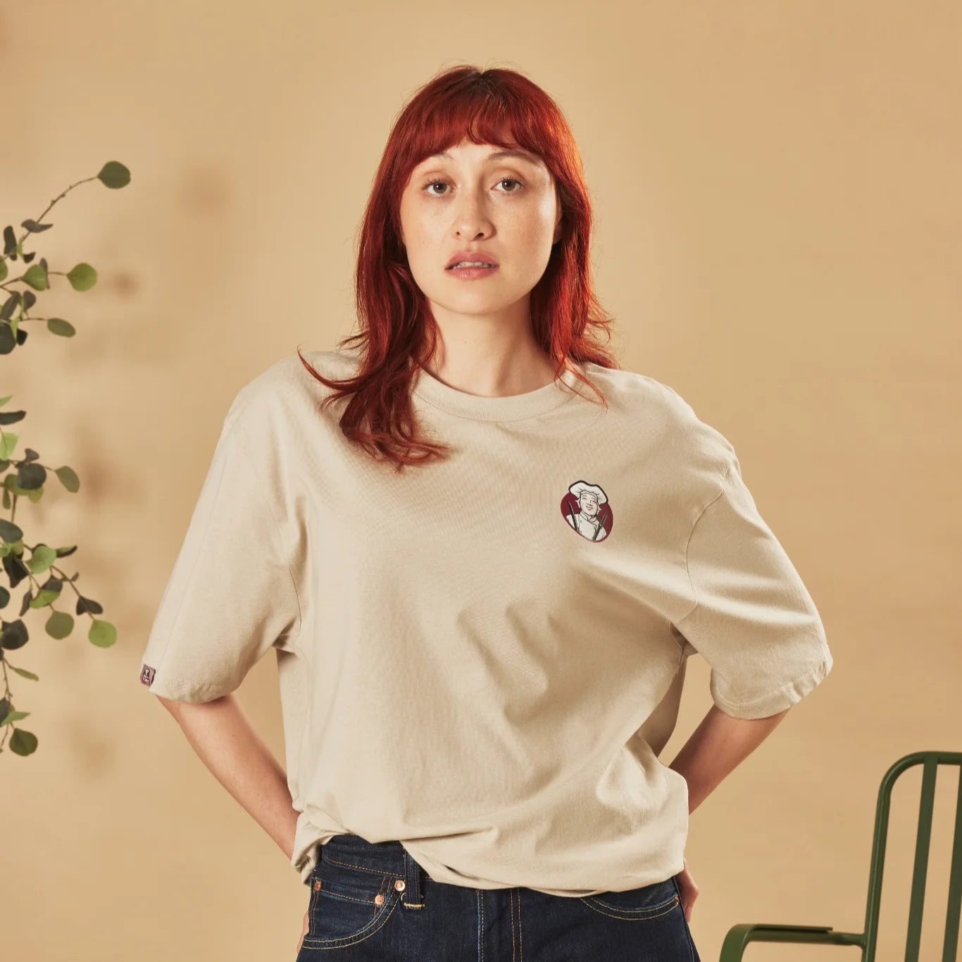 Person wearing a natural stone t-shirt with a Toby Carvery logo on a beige background